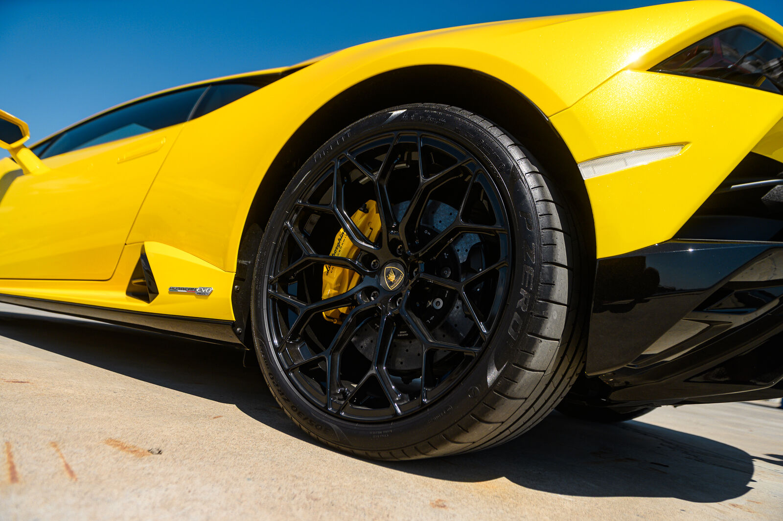 Rear Forged Narvi wheel low-angle against blue sky